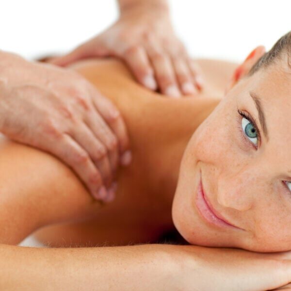 Smiling woman enjoying a massage in a spa center